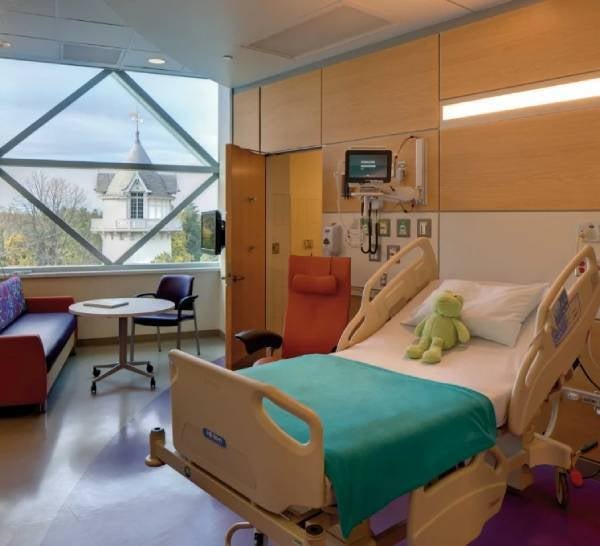 Small toy frog is plaed on Hospital bed.