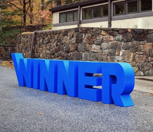 Winner is written in letters placed on road.